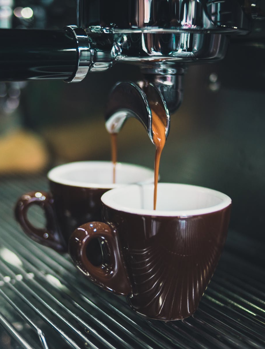 Espresso being poured into two small cups